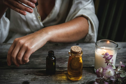 Person applying THC oil extraction drops to arm for therapeutic use.