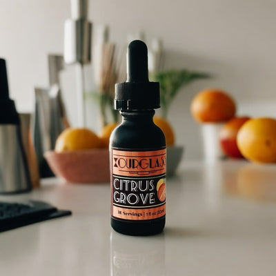 OURGLASS Citrus Grove delta 9 tincture bottle on a kitchen counter with fresh fruits, showcasing thc tincture for an active lifestyle.