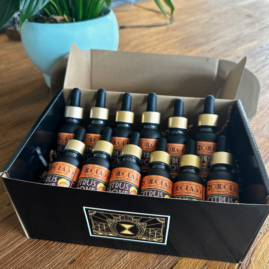 OURGLASS: A box filled with various delta 9 tincture bottles, showcasing a variety of thc tincture options for different tastes and preferences.