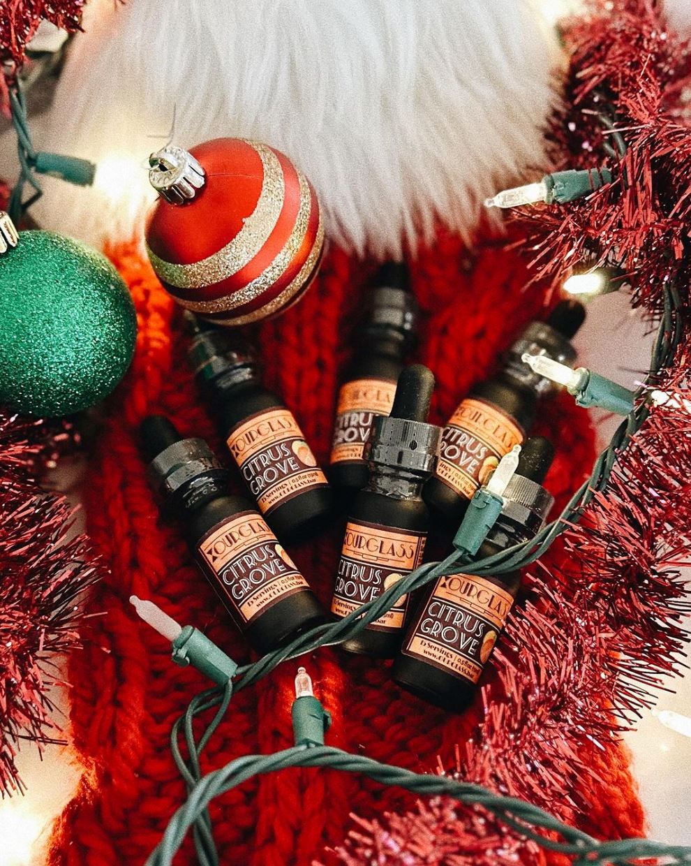 OURGLASS Citrus Grove delta 9 tincture bottles in a festive Christmas setting, perfect for holiday-themed thc drops and delta 9 beverages.